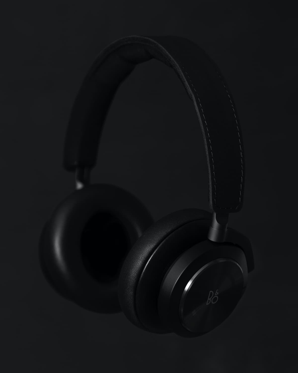 Black headphones against a dark grey background